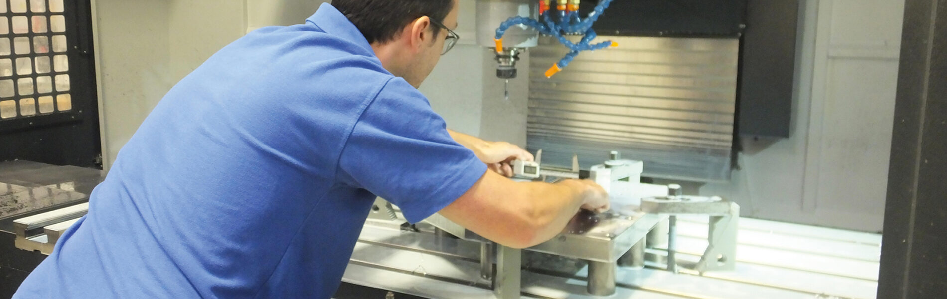 Hyfore employee setting up fixtures in a CNC milling machine